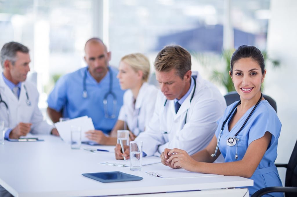 Professionals discussing home loan options with LMI waiver benefits to reduce upfront buying costs